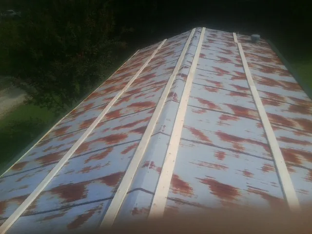 Rusted metal roof panels with new wood purlins before replacement — Storm Damage Roof Repair in Menifee by Roofing Brothers