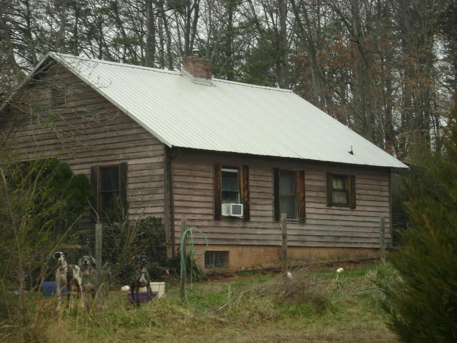 White metal roof on an old wood sided farmhouse, from a Metal Roof Installation job in Menifee